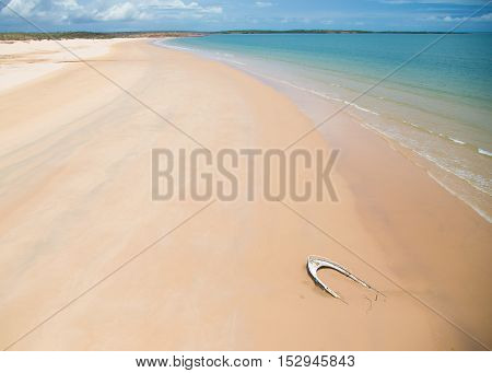 A lonely wrecked boat on a pristine and very remote beach in the Kimberley at the Northern tip of Western Australia