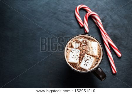 Hot Chocolate with marshmallows and candy stick traditional beverage for winter time