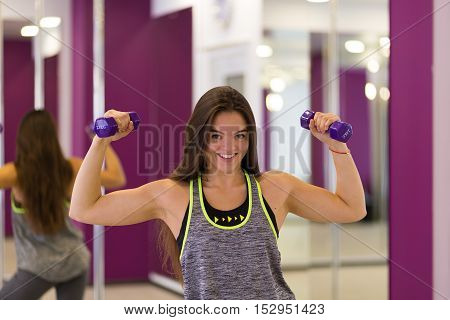 Pretty woman working out at the gym