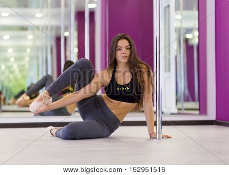 Pretty woman doing yoga in the studio