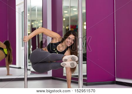 Pretty woman doing yoga in the studio