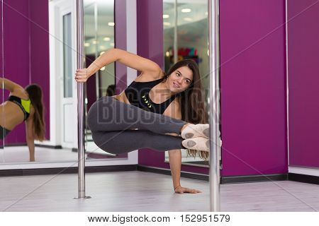 Pretty woman doing yoga in the studio