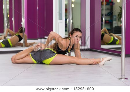 Pretty woman doing yoga in the studio