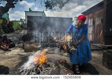 Chichicastenango Guatemala - April 24 2014: Maya woman performing a traditional mayan ritual in the cemetery of the town of Chichicastenango in Guatemala