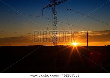 Decrease in the area and a power line on a sunset
