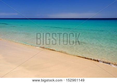 View on the beach with crystal sea water in Morro Jable on the Canary Island Fuerteventura Spain.