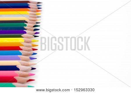 Colored pencils isolated on white background. Bright template with copyspace. Educational background.