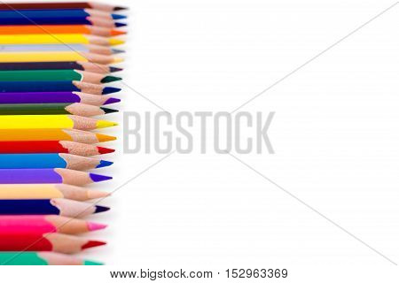 Colored pencils isolated on white background. Bright template with copyspace. Educational background.