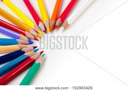 Colored pencils isolated on white background. Bright template with copyspace. Educational background.