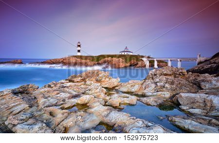 Idyllic view on seashore of Pancha island Spain at sunset of pink and purple colors
