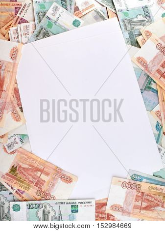 White paper sheet blank on the background a large number of rubles.