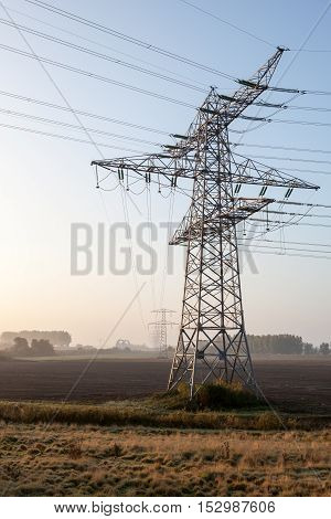 on a pasture in Germany there is a high voltage pole