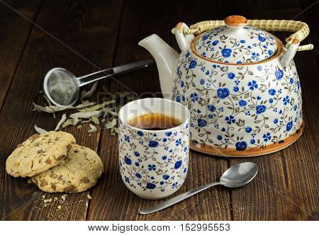 Morning tea with biscuits on natural wooden table.