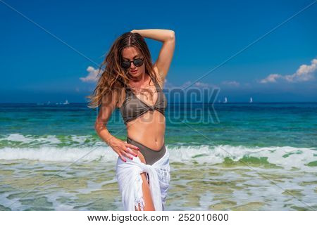 woman sunbathing on the beach summer travel holidays