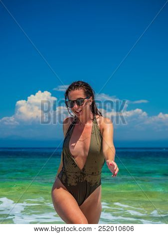woman sunbathing on the beach summer travel holidays