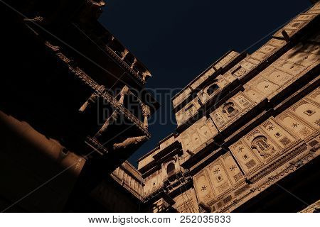 Ancient Building With The Dark Sky From The Bottom View Of Two Parts With Wide Angle