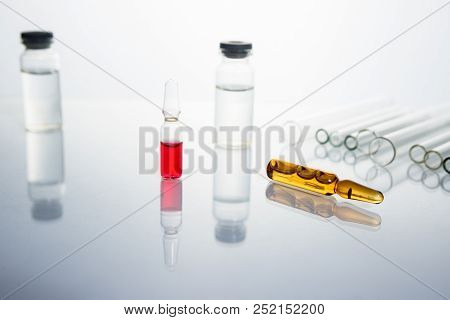 Group Of Vials With Medication On Blue Methacrylate Table. Horizontal Composition.