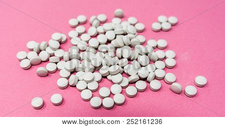 A Lot Of Gray Round Pills On Pink Background
