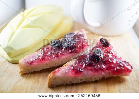 Morning Breakfast Have Blueberry Jam And Currants On Brown Bread With Mango. It Is Healthy Food And 