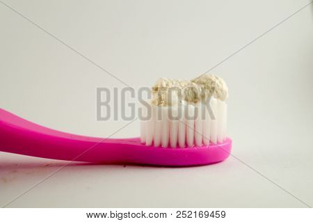 Herbal Toothpaste On Pink Toothbrush Isolated White Background