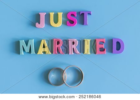 Multicolored Inscription Just Married On A Blue Background