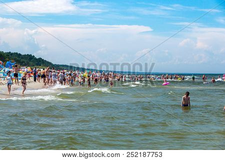 Krynica Morska, Poland - July 11, 2018: People Bathing In The Baltic Sea.