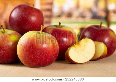 Group Of Lot Of Whole Two Slices Of Fresh Red Apple James Grieve Variety With Cart In Background