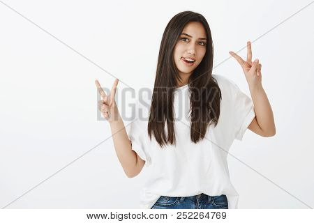 Portrait Of Joyful Attractive Female Student In White T-shirt And Jeands, Sticking Out Tongue And Ra