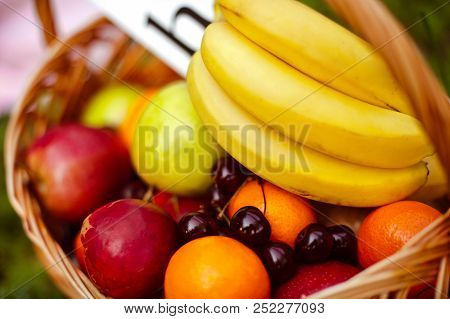 A Fruit Basket On The Grass In The Park