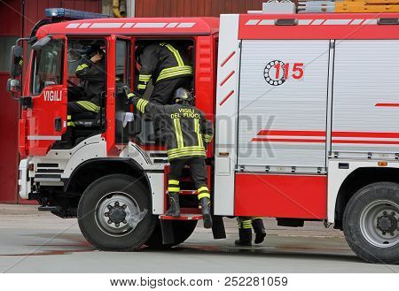 Italia, It, Italy - May 10, 2018: Fire Truck And Talian Firefighters With Uniform During Fire Drill.