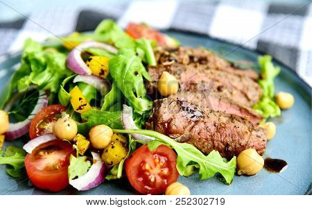 Steak Salad With Honey Soy Pan Sauce On Blue Dish.
Beef Salad With Arugula And Chickpeas.
