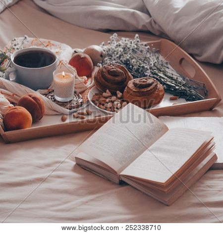 Breakfast In Bed, A Tray Of Tea, Croissants, Fruit, Flowers. Morning. Cozy Apartment. Open The Book 