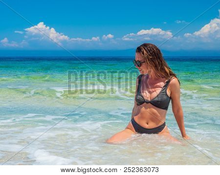 woman sunbathing on the beach summer travel holidays