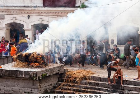 KATHMANDU, NEPAL - JULY 12, 2018: Temple crematorium Pashupatinath. 
People believe that cremation will give a spiritual rebirth