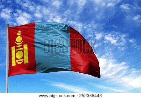 National Flag Of Mongolia On A Flagpole In Front Of Blue Sky