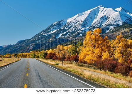 Highway in Colorado Rocky Mountains at autumn, USA. Mount Sopris landscape.