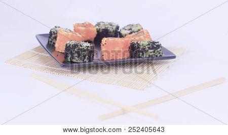 Different Types Of Maki Sushi On A Black Plate