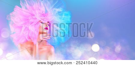 High Fashion model woman in colorful bright lights posing, portrait of beautiful sexy girl with trendy make-up and colourful pink hairdo. Art design, colorful make up. Vivid makeup. Wide angle