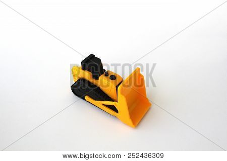 Isolated Toy Bulldozer With White Background In Yellow And Black Colors
