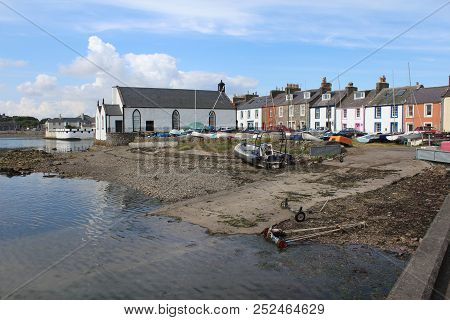 View Of The Pictureque Harbour And Surrounding Buildings At The Isle Of Whithorn In Dumfires And Gal