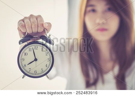 Beautiful Asian Young Woman Wake Up In Morning Annoyed Alarm Clock Holding Hand, Girl Hurry Wake Lat