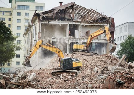 excavator crasher machine at demolition on construction site
