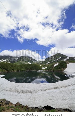 Mikurigaike Pond And Tateyama Mountain Range With Snow In Summer In Toyama, Japan
