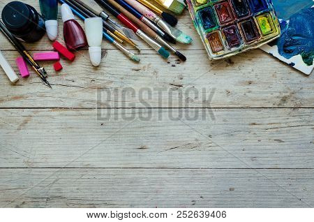 Artist Paint Brushes And Watercolor Paintbox On Wooden Background With Place For Text. Instruments A
