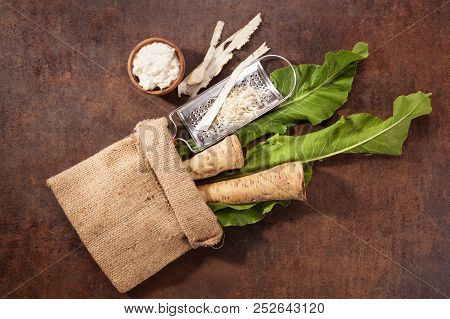 Raw Horseradish Roots And Grated Horseradish With Leaf On Grunge Background From Above. Healthy Vege