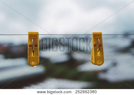 Couple Plastic Clothes Peg. Royalty High Quality Stock Photo Of Two Yellow Plastic Clothes Peg Cloth