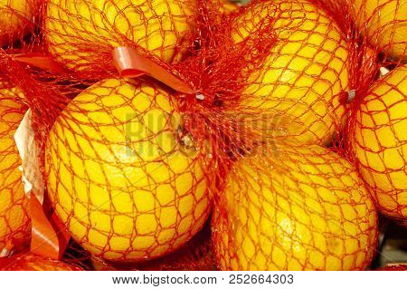 Fresh Oranges Packed In Bright Crane Mesh