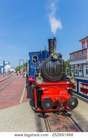 Borkum, Germany - July 25, 2018: Historic Steam Train Locomotive In The Center Of Borkum Village In 