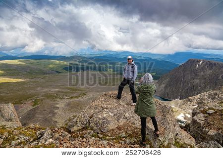 Travel Lifestyle And Survival Concept Rear View. Photographer  Woman Traveler, Enjoys A Hike And Pho