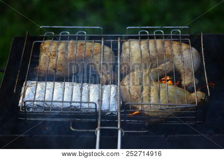 Preparation On Bbq. Hot Tasty Smokey Barbecue Meal At Coals And Burnt Firewood. Cooking On Fire Outd